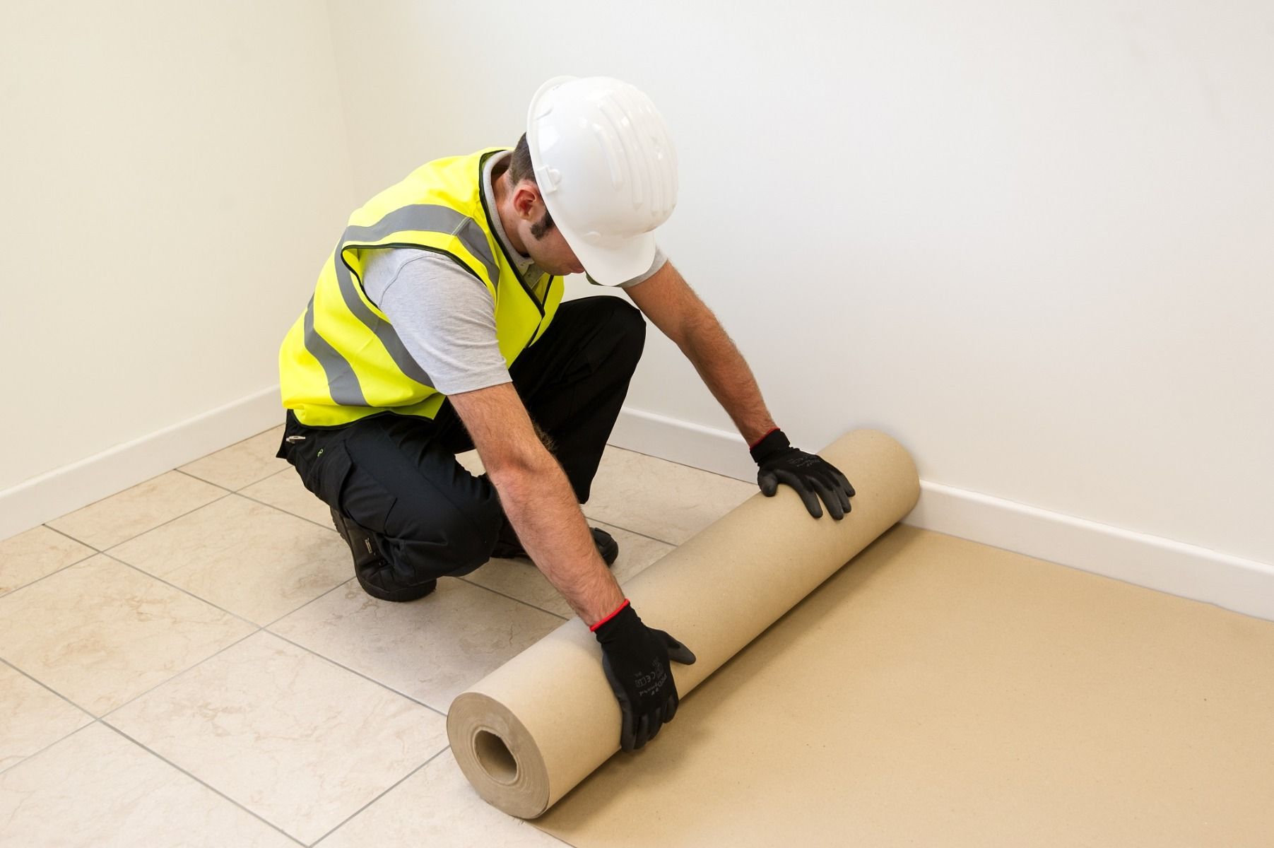 Man laying down card floor protection