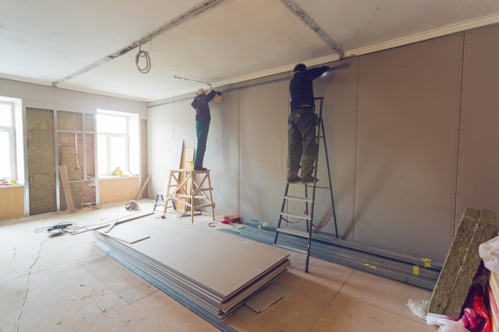 Workers are installing plasterboard